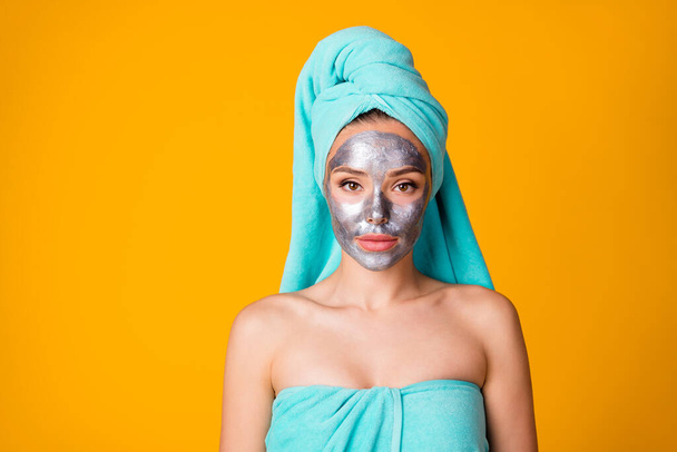Photo of young attractive woman bodycare facial treatment spa procedure teal towel isolated over yellow color background - Foto, Imagen