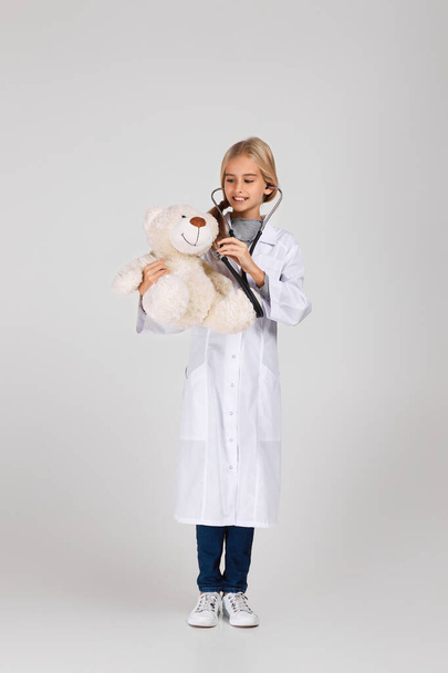 Cute child in doctor coat with stethoscope - Фото, зображення