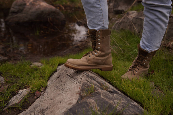 Woman wearing stylish hiking boots on rock, closeup - Photo, Image