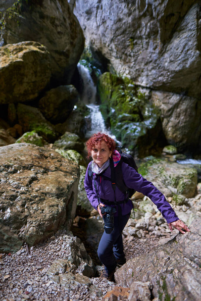 Tourist lady with camera hiking in the limestone mountains - Фото, зображення