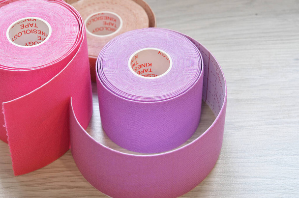 Kinesiological tape rolls. Anti-pain taping for athletes for weight loss, anti-wrinkle - Φωτογραφία, εικόνα