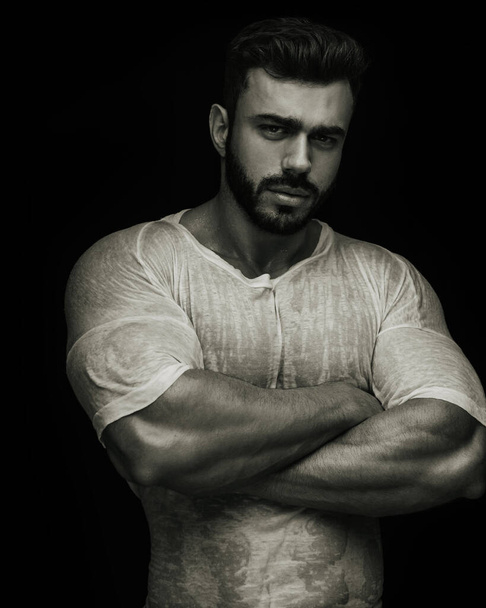 Portrait of handsome male fitness model crossing his arms - Photo, Image