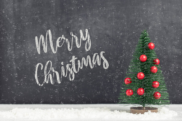 Merry Christmas. Decorative fir tree with colorful ball ornament and snow - Φωτογραφία, εικόνα