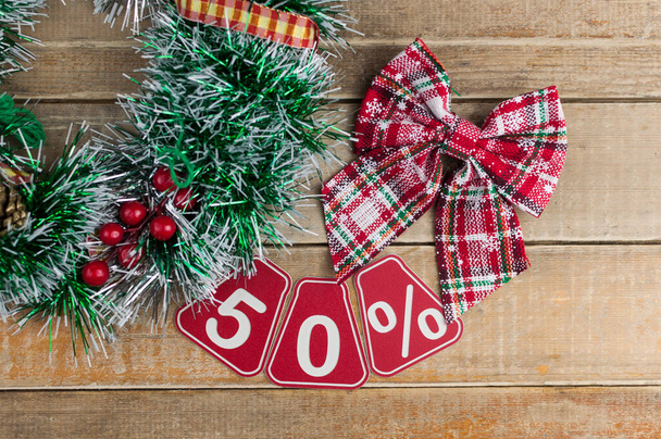 Big sales 50%, fifty percents with Christmas wreath on a old barn plank background, top view, copy space. Christmas big sale.  - Photo, Image