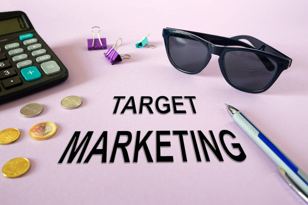 Text writing TARGET MARKETING. Calculator, money and glasses on the table - Photo, image