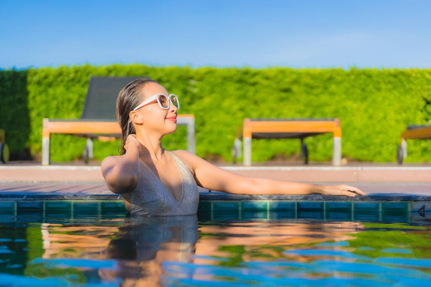 Portrait beautiful young asian woman relax smile leisure around outdoor swimming pool in hotel resort - Photo, Image
