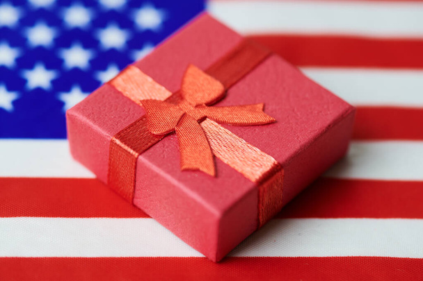 Gift box on USA flag. American gift for nation. Green card or 4th july independence day United States present concept. - Photo, Image
