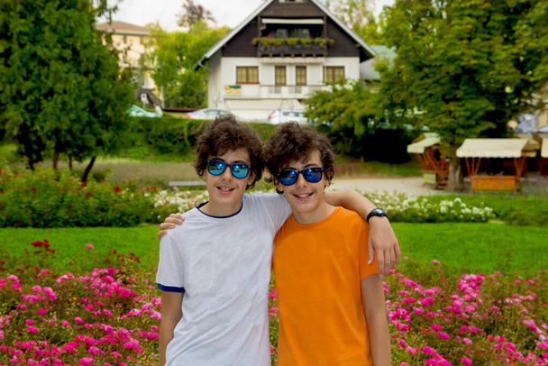Portrait of happy twins looking at camera in Bled, Slovenia - Φωτογραφία, εικόνα