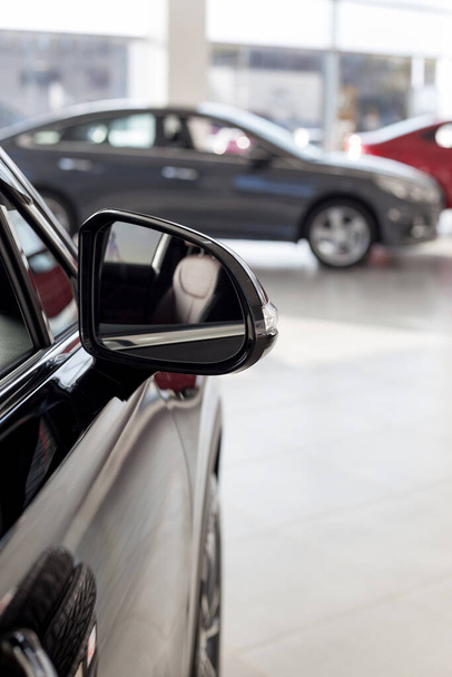 New modern cars at dealer showroom. Themed blur background with bokeh effect. Car auto dealership. Prestigious vehicles. - Foto, Imagem