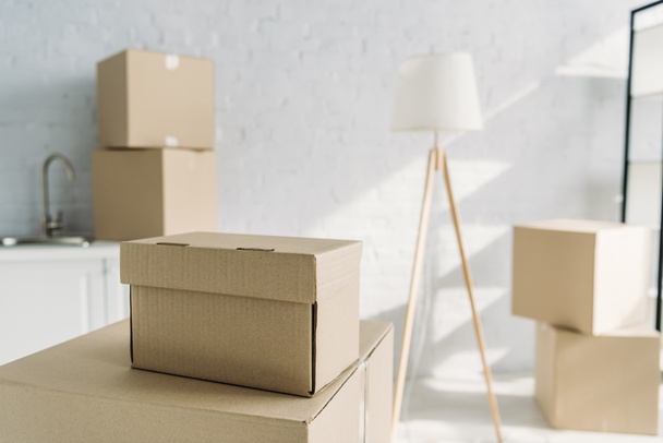 carton boxes near floor lamp on blurred background  - Photo, Image