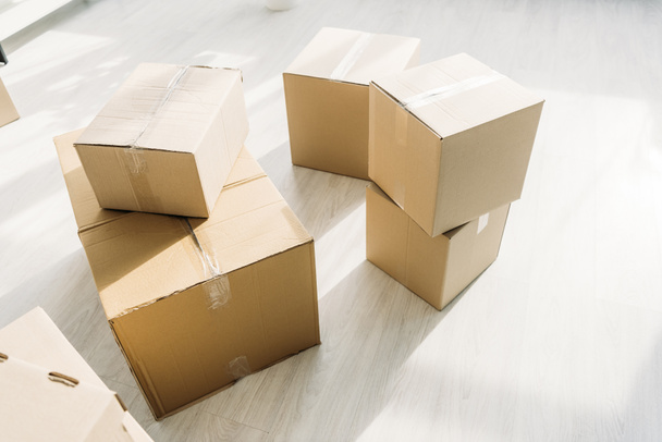 stacked carton boxes on floor in modern apartment  - Valokuva, kuva