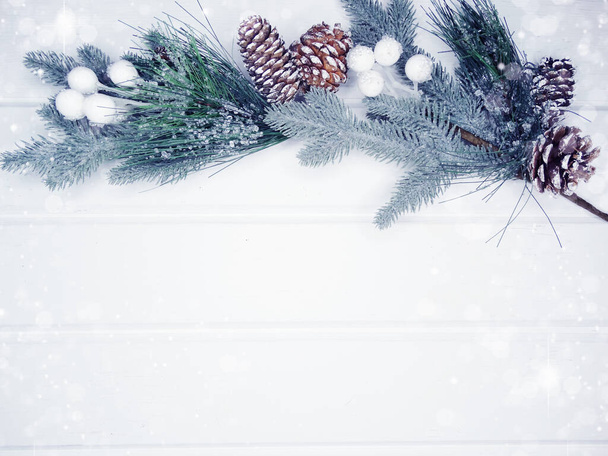 winter christmas background with fir branches cones and snow on white wooden texture                               - Foto, Bild