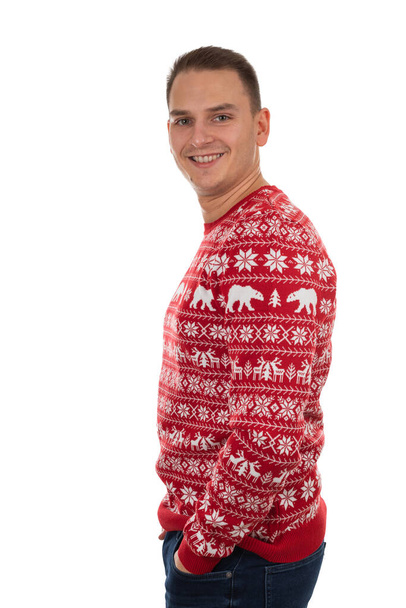 Portrait of handsome young man wearing christmas theme knitted blouse on isolated background - Фото, зображення