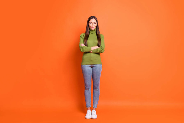 Full size photo of young attractive woman happy smile crossed hands confident isolated over orange color background - 写真・画像
