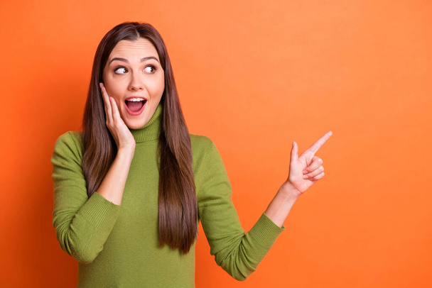 Photo of young attractive happy shocked amazed girl hold hand cheek point finger copyspace isolated on orange color background - Φωτογραφία, εικόνα