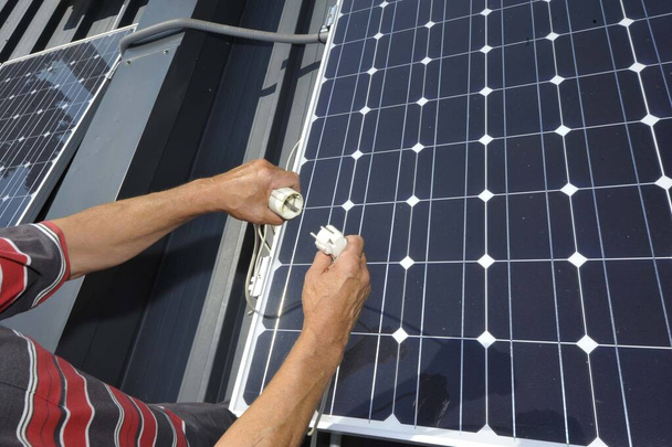 a power plug and solar panel, sustainable and ecological energy production - Photo, Image