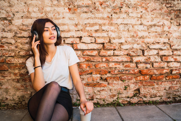 Young woman listening music with headphones. - Fotoğraf, Görsel