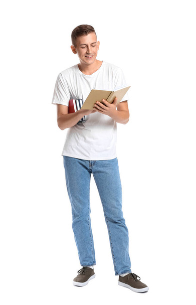 Young man with books on white background - Photo, Image