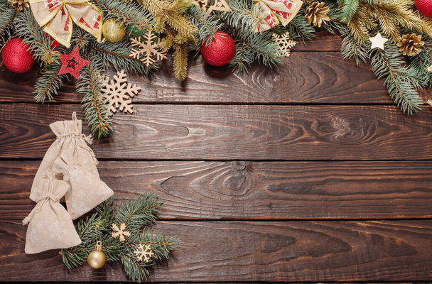 fir branches with Christmas decor on old dark wooden background - Φωτογραφία, εικόνα