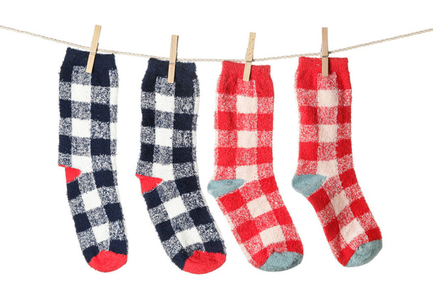 Warm socks hanging on clothes line against white background - Photo, Image