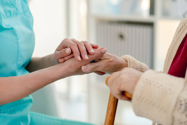 Senior woman hand in caregiver hands - 写真・画像