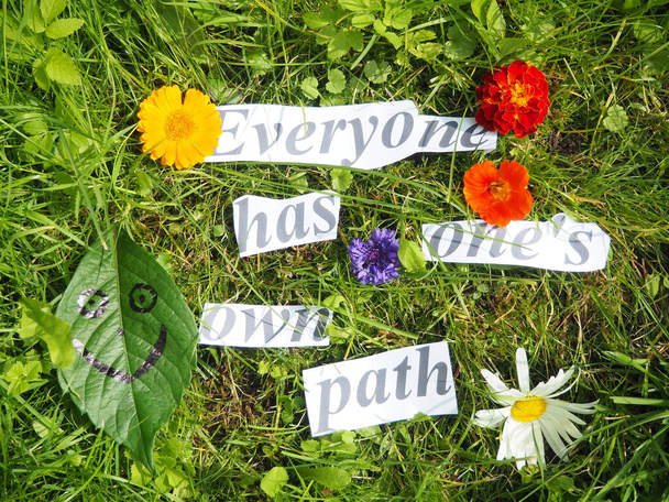 everyone has one's own path.paper cut words on grass - Φωτογραφία, εικόνα