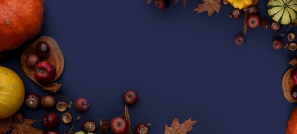 autumn composition with pumpkins, apples and chestnuts on blue background - Foto, Imagem