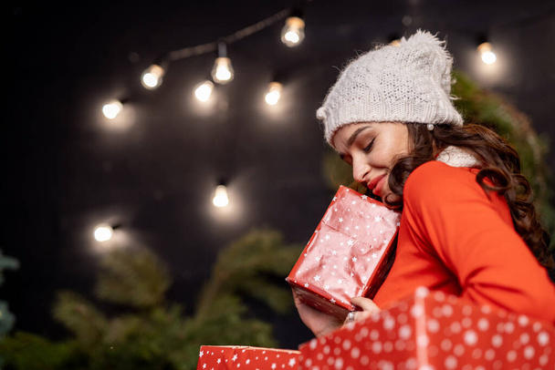 Woman with big christmas presents. Lady in good mood before holidays. New year and Christmas concept. - Photo, Image