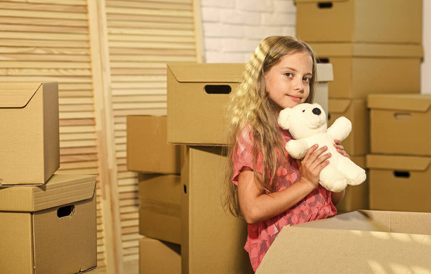 Excited about new house. Girl child play with toy near boxes. Move out concept. Prepare for moving. Moving out. Packaging things. Rent house. Family house. Delivering service. Apartment for family - Fotografie, Obrázek