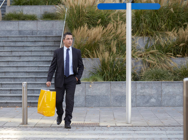 businessman walking with shopping bag - Photo, image