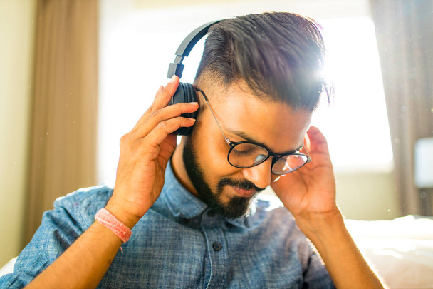 bearded arabian man listening audio meditation business training personal growth in new apartment - Photo, Image