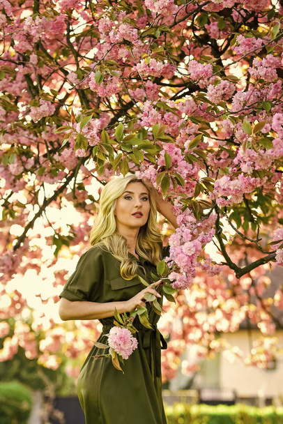 Cherry tree. Floral aroma. Reasons why flowers always make women happy. Happy spring day. Perfume and cosmetics. Spring symbol. Girl enjoy sakura in garden. Rest relax and vacation. Spring blossom - Photo, Image