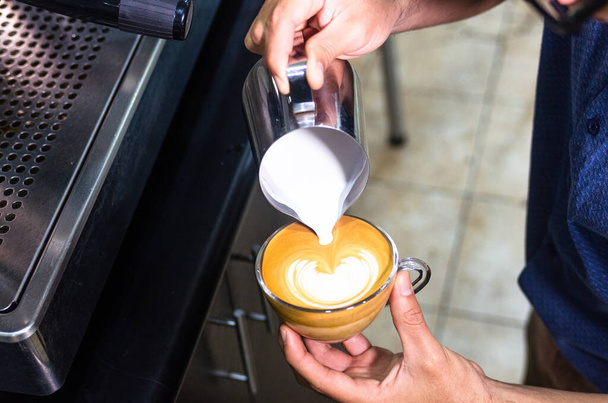 Kahve yapan baristanın eli ya da kapuçino yapan kahve yapan, süt döken, latte yapan.... - Fotoğraf, Görsel