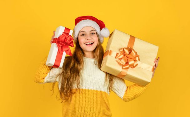 Christmas gifts for kids. Small cute girl preparing holiday gifts. Receiving presents. Kid little cheerful girl hold gift box. Satisfied with purchase. Shopping day. Child picking gifts for family - Zdjęcie, obraz