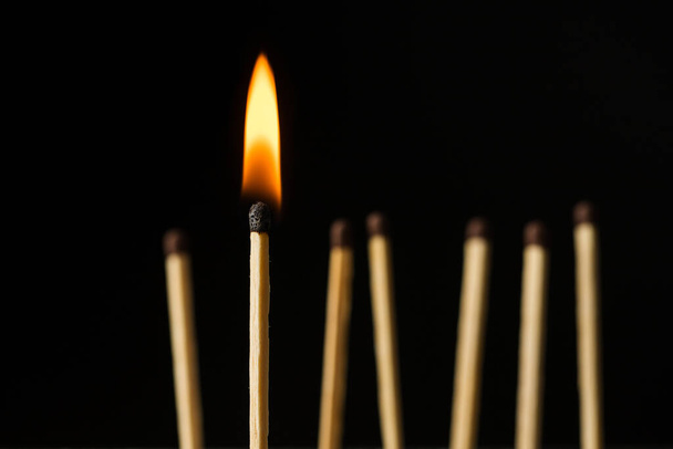 wooden lighted matches, standing on a black background - Photo, Image