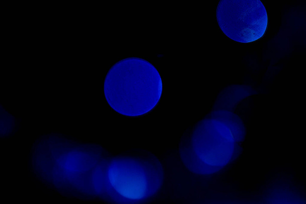 Abstract blue background. Bright curly fluffs on black. - Φωτογραφία, εικόνα