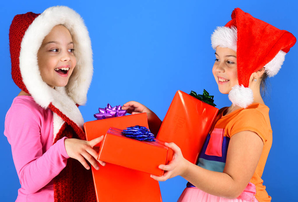 Children with happy faces give presents on blue background. - Φωτογραφία, εικόνα