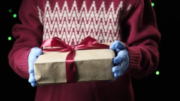 childs hands giving red box with white ribbon. christmas, new year concept - Footage, Video