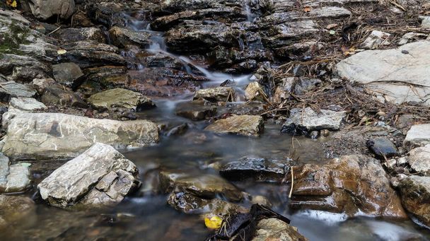 Blisko górska rzeka płynie między malowniczymi letnimi kamieniami. Skały w górach z płynącą wodą - Zdjęcie, obraz