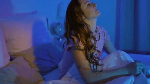 Jonge vrouw in bed wordt wakker - Video