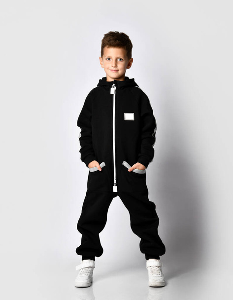 Boy in black warm jumpsuit trendy attire advert - Foto, Imagem