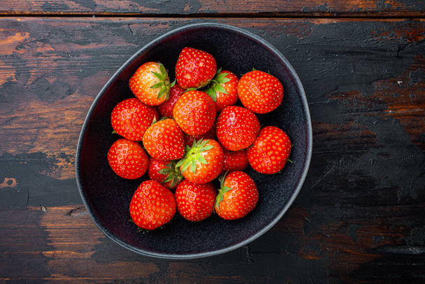 Ripe red strawberry, flat lay on old wooden background. - Photo, Image