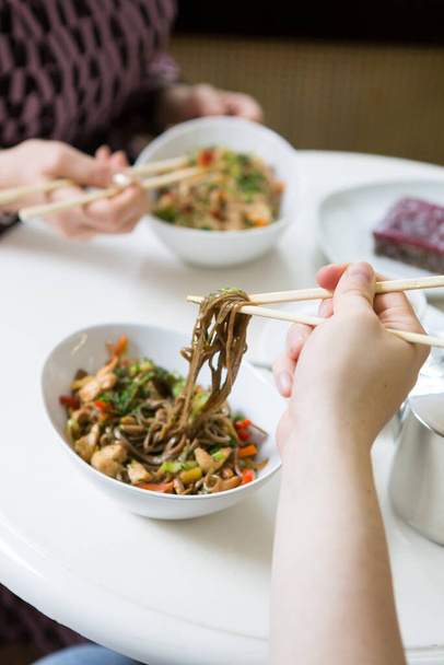 Bowl of fried noodles served on a table - 写真・画像