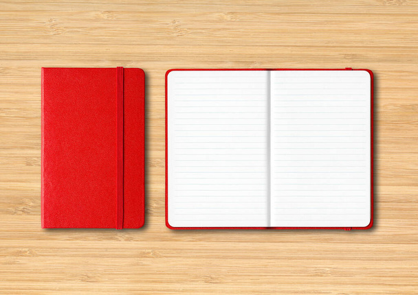 Red closed and open lined notebooks mockup isolated on wooden background - Fotó, kép