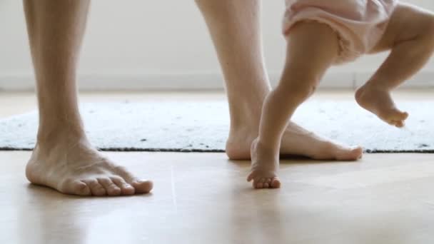 Imparare a piedi nudi bambino camminare con l'aiuto del padre - Filmati, video