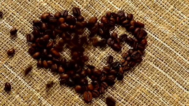 Hot Coffee Mixing with Pouring Milk Cream. Fragrant coffee beans are roasted in a frying pan, smoke comes from coffee beans. Close up of seeds of coffee. Fragrant coffee beans are roasted. coffee espresso closeup steam beverage hot. - Footage, Video