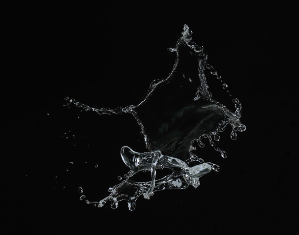 Water splash on black background - 写真・画像