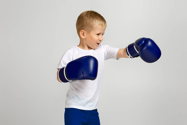 Boxing fighter boy in boxer gloves - Фото, изображение