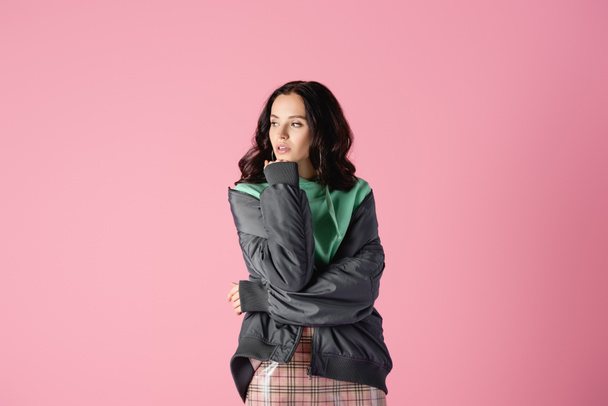 smiling brunette young woman in casual winter outfit posing on pink background - Φωτογραφία, εικόνα