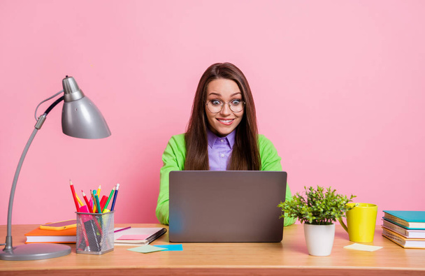 Photo of workaholic girl sit table work laptop wear green style shirt isolated pastel color background - Valokuva, kuva